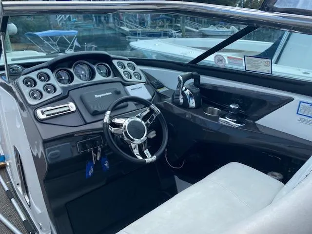 Slide: The Image of Interior of a 2015 Monterey 328 Super Sport boat with seating and dashboard. - 10