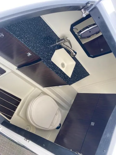 Slide: The Image of 2015 Monterey 328 Super Sport boat interior with white leather seats and windshield. - 16