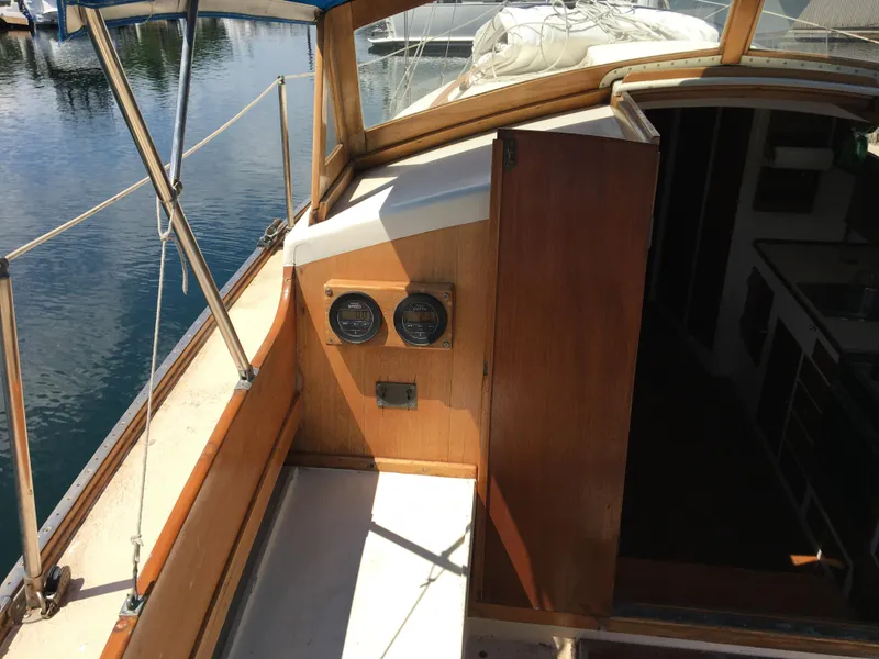 Slide: The Image of 1958 Custom 38' Sloop cockpit with wooden interior and nautical instruments. - 17
