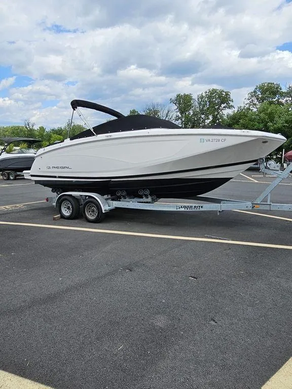 Slide: The Image of 2017 Regal 23 OBX boat on a trailer in a parking lot. - 0