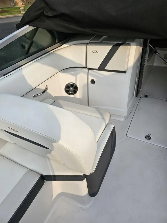 Slide: The Image of 2017 Regal 23 OBX boat interior with white seating and storage compartments. - 3