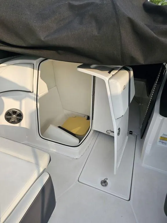 Slide: The Image of 2017 Regal 23 OBX boat interior storage compartment with open door. - 4