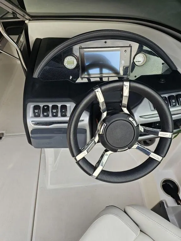 Slide: The Image of Steering console of a 2017 Regal 23 OBX boat with modern controls and touchscreen display. - 5