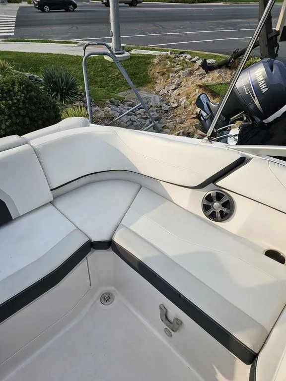 Slide: The Image of 2017 Regal 23 OBX boat interior with white seating and Yamaha outboard motor. - 6