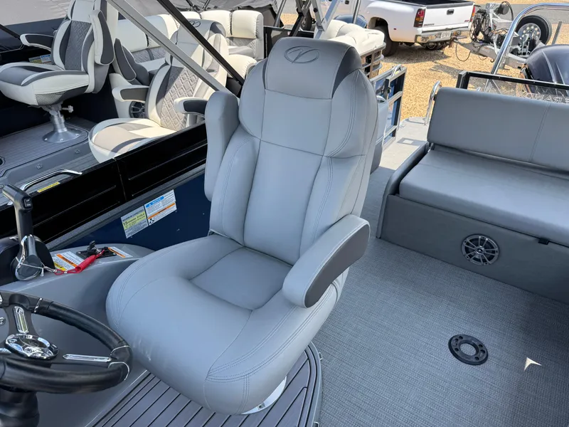Slide: The Image of 2023 Veranda VTX 25 VLB boat interior with luxurious seating and steering wheel. - 10