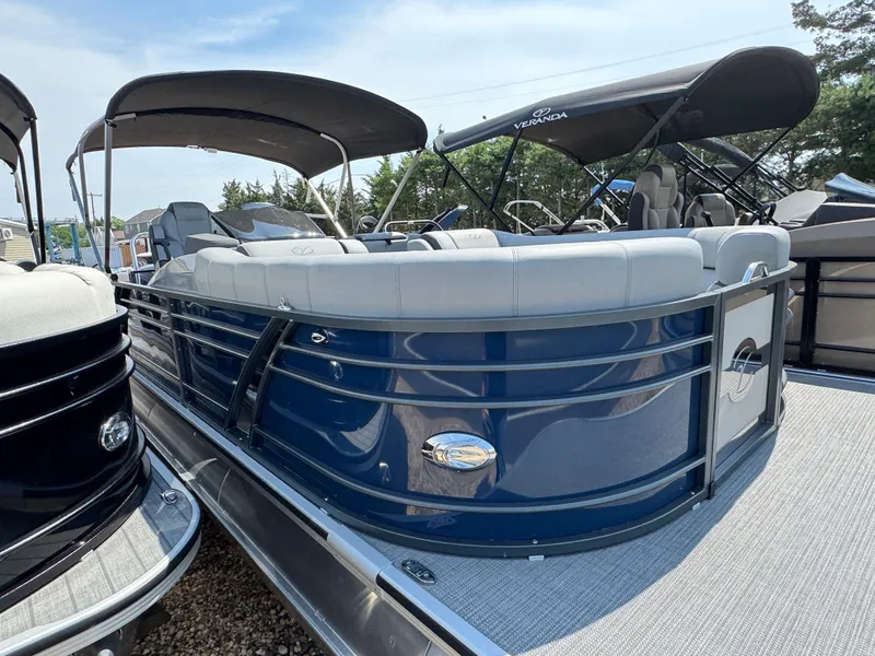 Slide: The Image of 2023 Veranda VTX 25 VLB pontoon boat with blue exterior and spacious seating. - 5