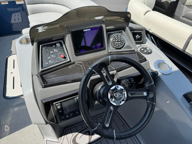 Slide: The Image of 2023 Veranda VTX 25 VLB boat dashboard with steering wheel and control panel. - 8