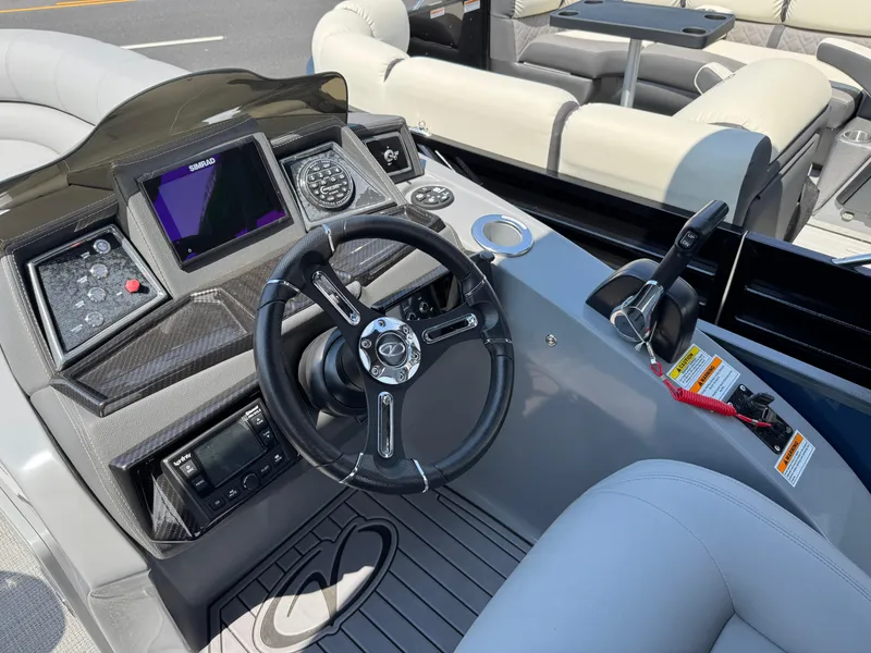 Slide: The Image of 2023 Veranda VTX 25 VLB boat dashboard with steering wheel and control panel. - 9