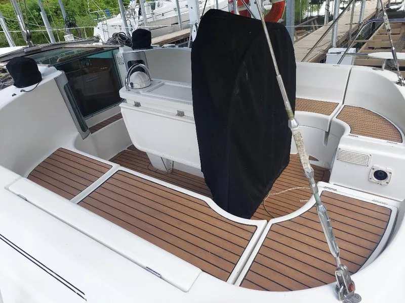 Slide: The Image of Cockpit of 1995 Beneteau Oceanis 351 sailboat with teak flooring and seating area. - 10