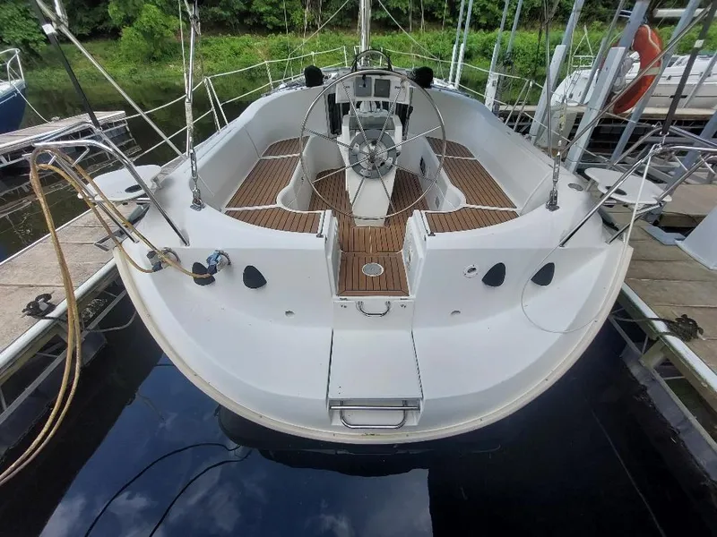 Slide: The Image of 1995 Beneteau Oceanis 351 sailboat with spacious cockpit and wooden deck, docked at marina. - 12