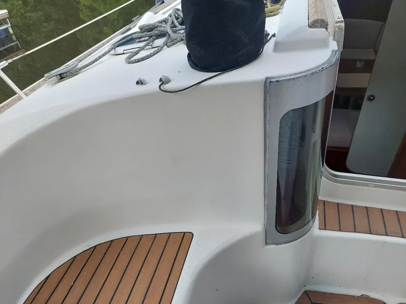 Slide: The Image of Beneteau Oceanis 351 sailboat deck, 1995 model, featuring teak flooring and cabin entrance. - 24