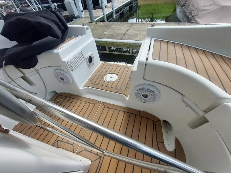 Slide: The Image of Beneteau Oceanis 351 sailboat deck, 1995 model, featuring teak flooring and stainless steel railings. - 35