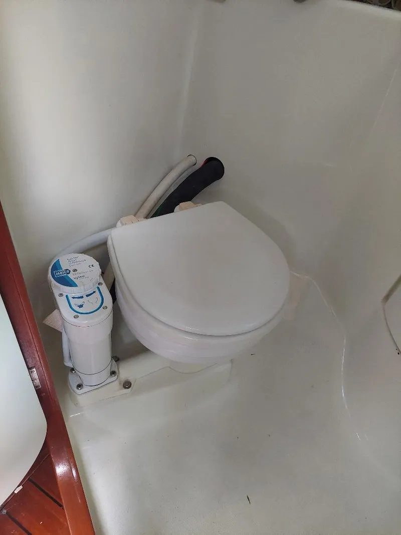Slide: The Image of 1995 Beneteau Oceanis 351 marine toilet in compact bathroom setting. - 36
