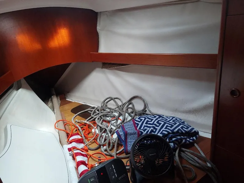 Slide: The Image of Interior of 1995 Beneteau Oceanis 351 sailboat with ropes, fan, and patterned bag. - 39