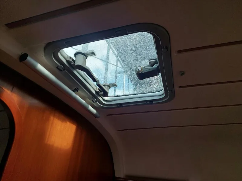 Slide: The Image of Interior view of a 1995 Beneteau Oceanis 351 hatch with wooden paneling. - 41