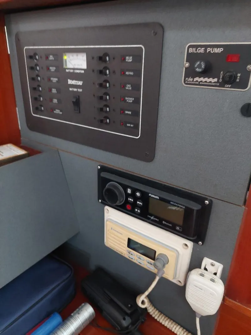 Slide: The Image of Control panel of a 1995 Beneteau Oceanis 351 sailboat, featuring electrical switches and bilge pump controls. - 44