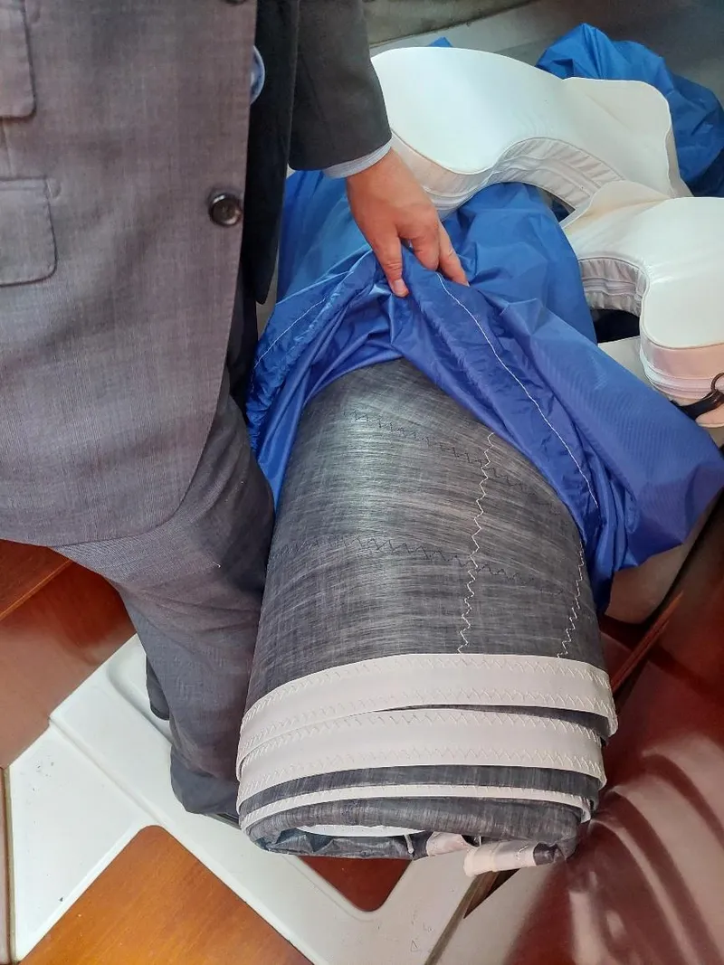 Slide: The Image of Person handling sail on 1995 Beneteau Oceanis 351 yacht interior. - 47