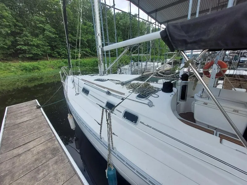 Slide: The Image of 1995 Beneteau Oceanis 351 sailboat docked, featuring sleek white design and rigging. - 5