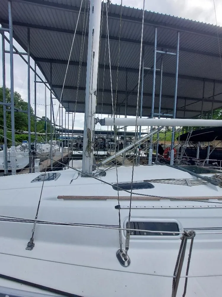 Slide: The Image of 1995 Beneteau Oceanis 351 sailboat docked under a covered marina. - 8