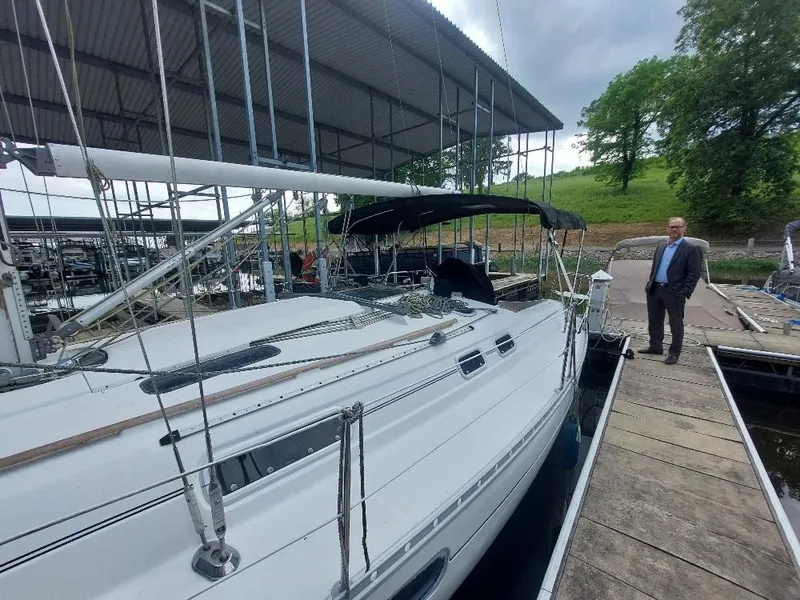 Slide: The Image of 1995 Beneteau Oceanis 351 sailboat docked at marina with a person standing nearby. - 9