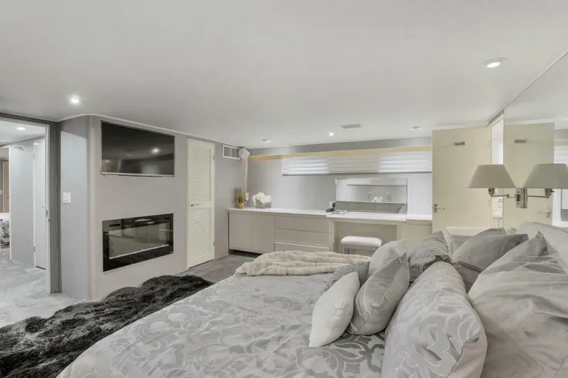 Slide: The Image of Luxurious bedroom interior of 1983 Broward 108 Cockpit Motor Yacht with modern decor. - 12