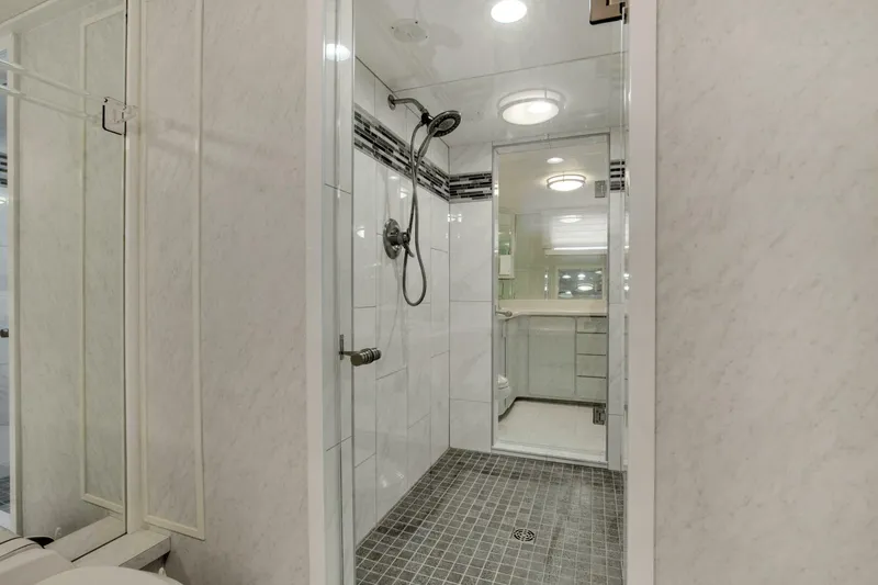 Slide: The Image of Luxurious bathroom in 1983 Broward 108 Cockpit Motor Yacht with modern shower. - 21