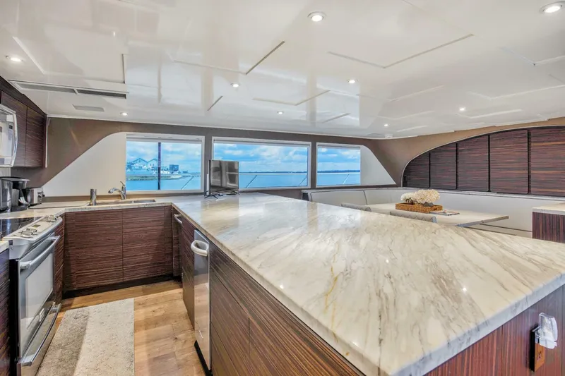 Slide: The Image of Luxurious kitchen interior of 1983 Broward 108 Cockpit Motor Yacht with marble countertops. - 22