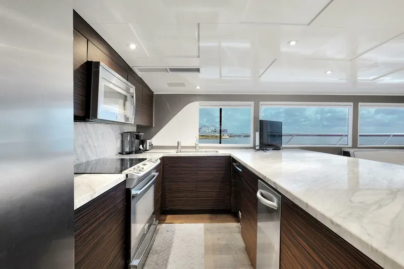 Slide: The Image of Modern kitchen on 1983 Broward 108 Cockpit Motor Yacht with ocean view. - 26