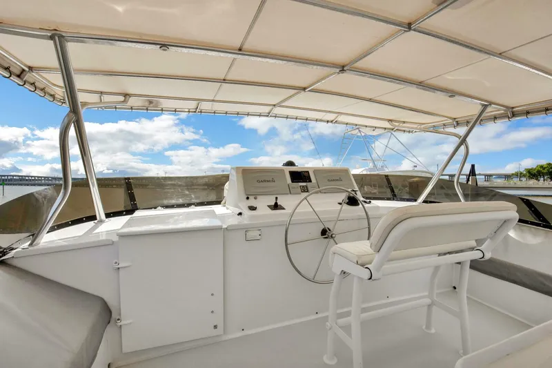 Slide: The Image of 1983 Broward 108 Cockpit Motor Yacht helm station with panoramic views - 40