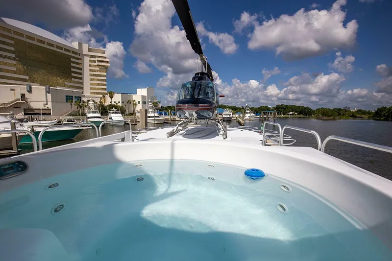 Slide: The Image of 1983 Broward 108 Cockpit Motor Yacht with hot tub and helicopter on deck. - 43