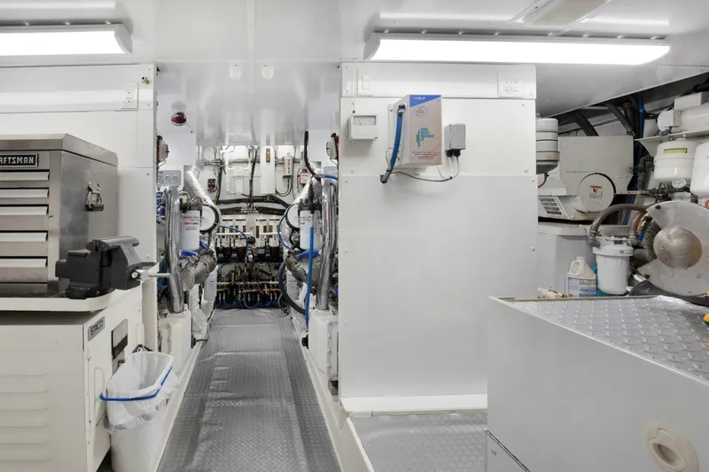 Slide: The Image of Engine room of a 1983 Broward 108 Cockpit Motor Yacht with machinery and equipment. - 45