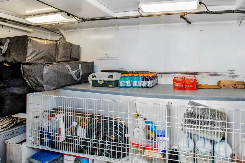 Slide: The Image of Storage area inside 1983 Broward 108 Cockpit Motor Yacht with supplies and equipment. - 47