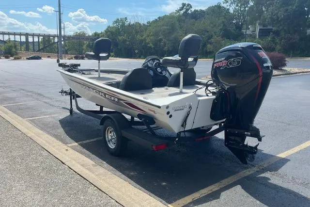 Slide: The Image of 2024 Tracker Pro Team 190 TX boat with motor in parking lot. - 2