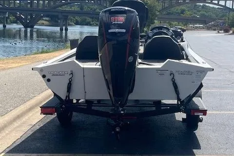 Slide: The Image of 2024 Tracker Pro Team 190 TX boat on trailer by riverside bridge. - 3