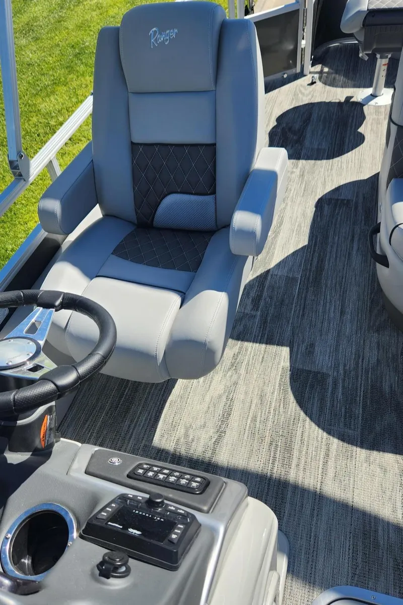Slide: The Image of 2024 Ranger Reata 223F boat interior with captain's chair and control panel. - 17