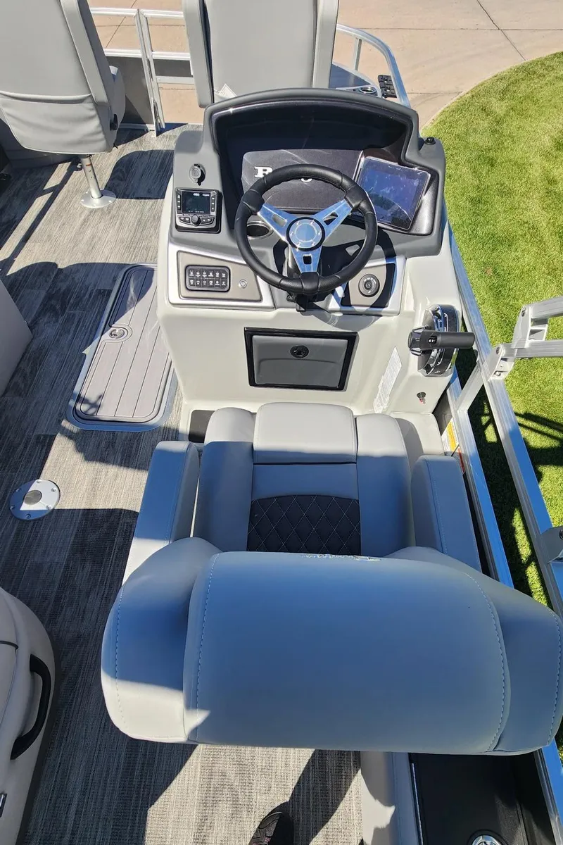 Slide: The Image of 2024 Ranger Reata 223F boat cockpit with steering wheel and control panel. - 18
