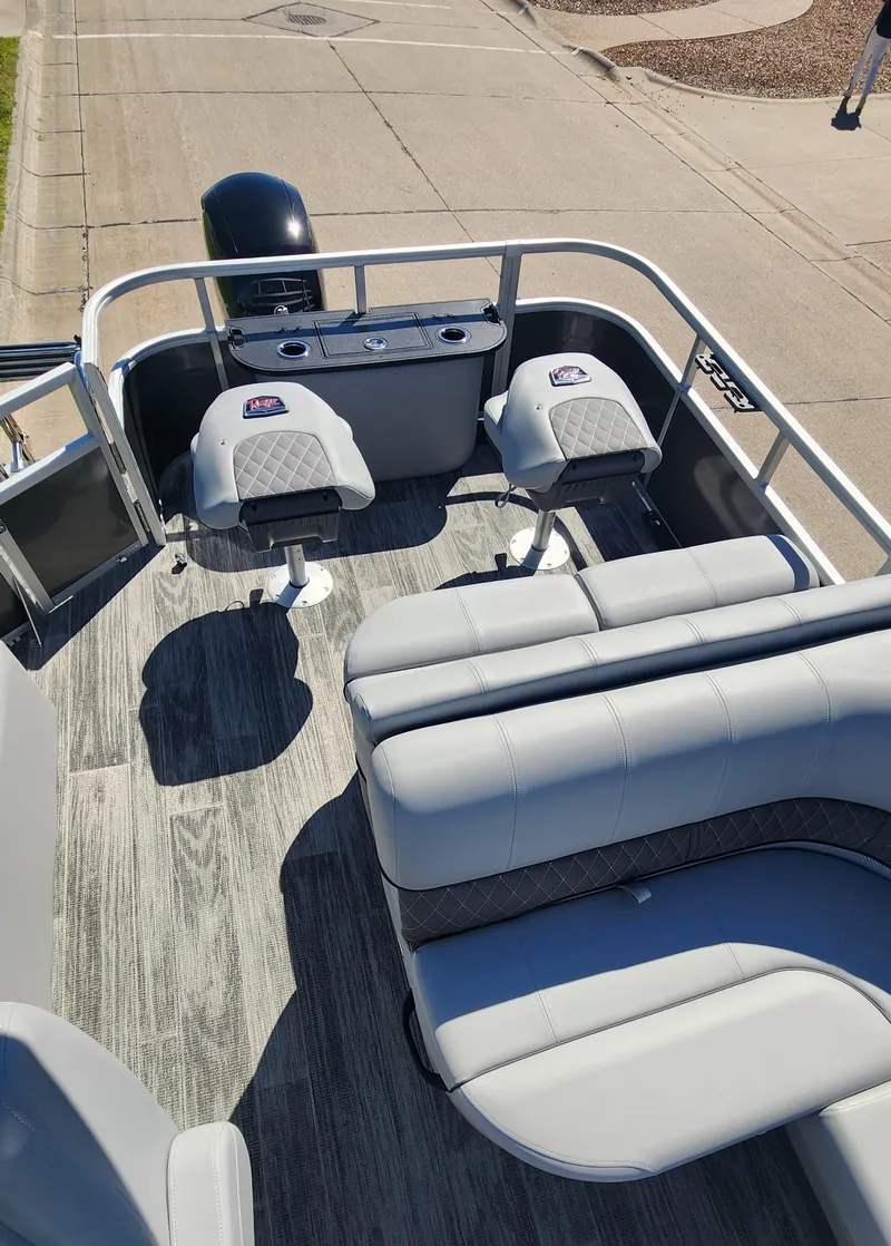 Slide: The Image of 2024 Ranger Reata 223F pontoon boat interior with seating and console. - 3