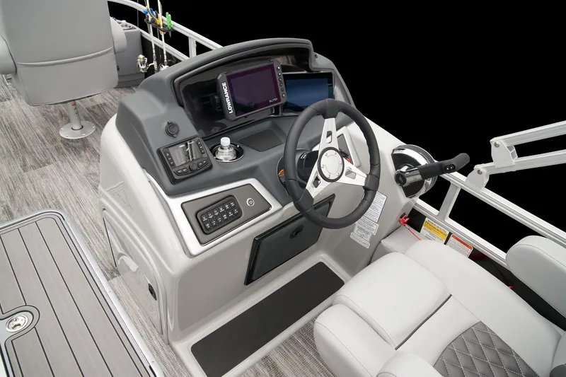Slide: The Image of 2024 Ranger Reata 223F boat console with steering wheel, navigation system, and control panel. - 36
