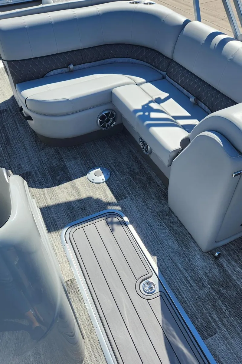 Slide: The Image of 2024 Ranger Reata 223F boat interior with gray seating and flooring. - 4