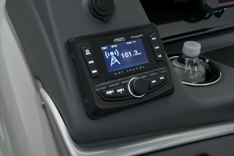 Slide: The Image of 2024 Ranger Reata 223F boat dashboard with radio and cup holder. - 43