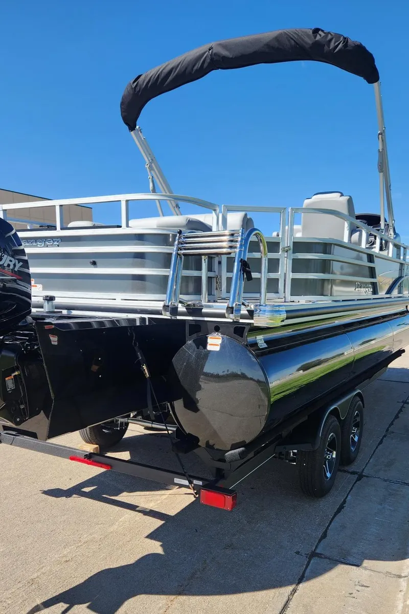 Slide: The Image of 2024 Ranger Reata 223F pontoon boat with black pontoons and a canopy. - 5