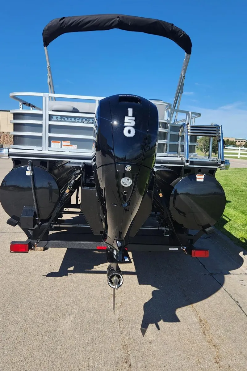Slide: The Image of 2024 Ranger Reata 223F pontoon boat with 150 HP outboard motor. - 6