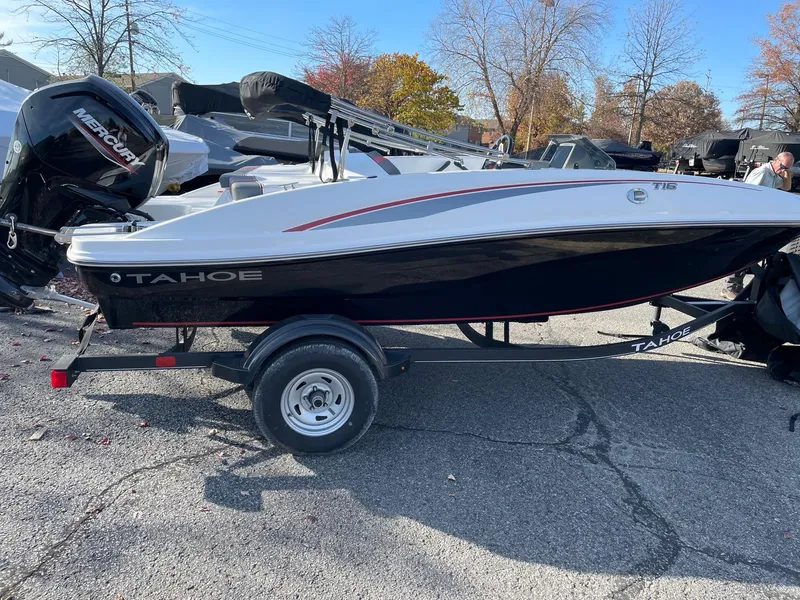 Slide: The Image of 2024 Tahoe T16 boat on trailer, side view, outdoors. - 0