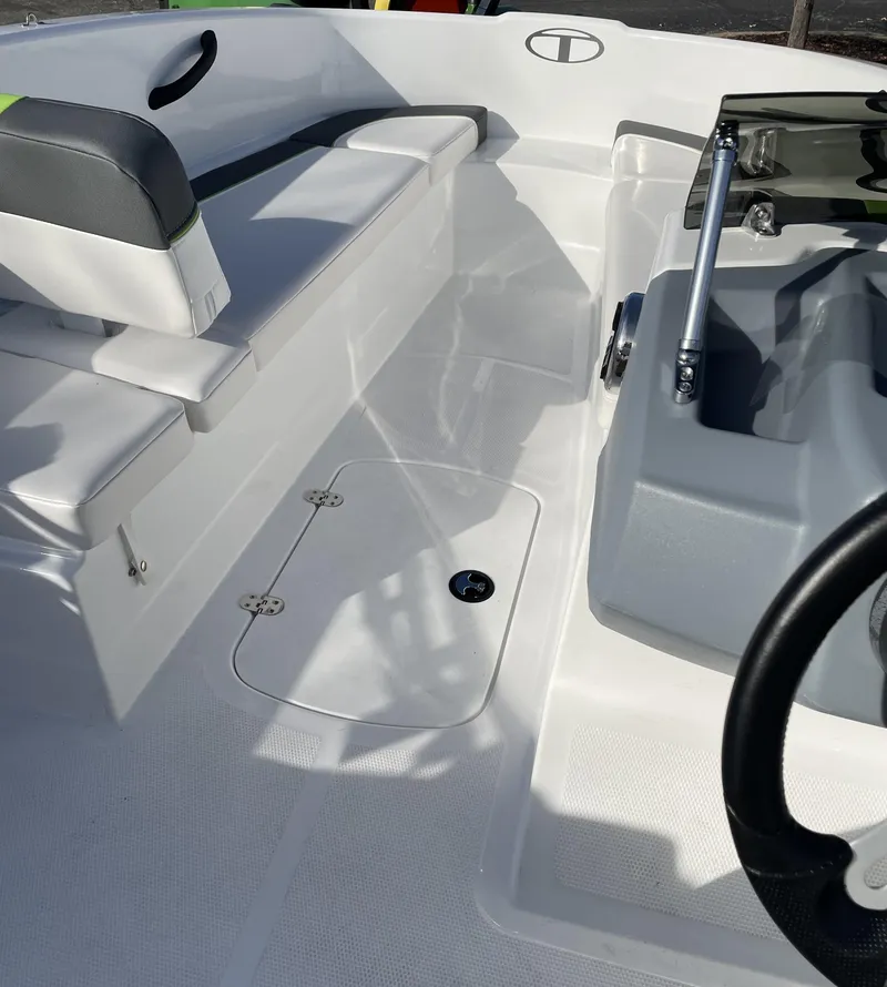 Slide: The Image of 2024 Tahoe T16 boat interior with seating and steering console. - 1