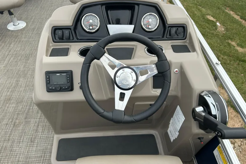 Slide: The Image of 2024 Ranger Reata 200F pontoon boat with Mercury 90 engine, parked outdoors. - 2