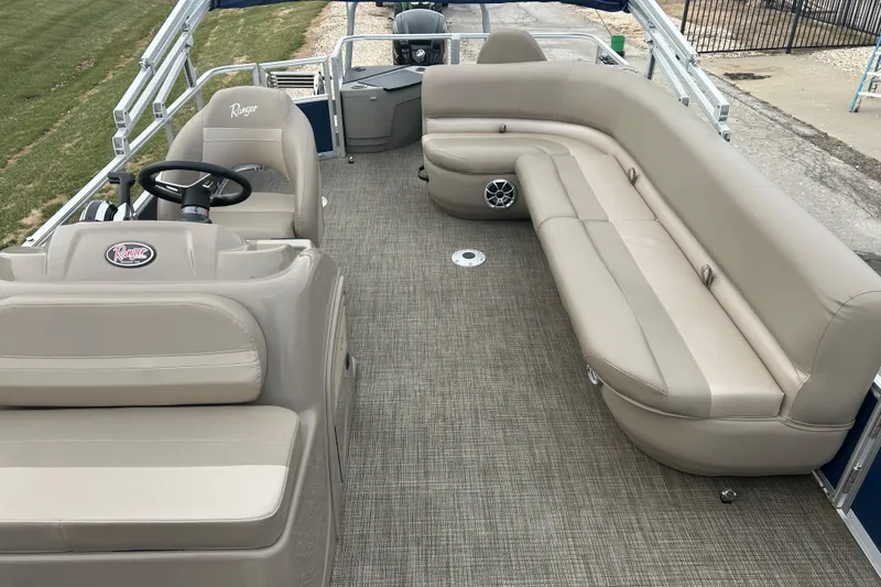 Slide: The Image of 2024 Ranger Reata 200F boat dashboard with steering wheel and controls. - 4