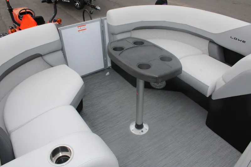 Slide: The Image of 2023 Lowe SS210 Super Sport boat interior with seating and table. - 10