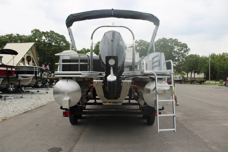 Slide: The Image of 2023 Lowe SS210 Super Sport pontoon boat rear view with outboard motor and ladder. - 3