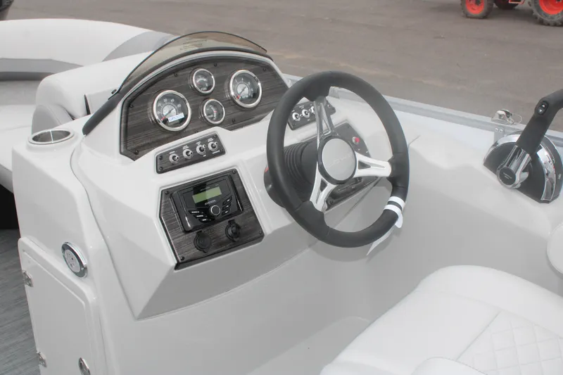 Slide: The Image of 2023 Lowe SS210 Super Sport boat dashboard with steering wheel and control panel. - 8