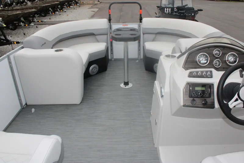 Slide: The Image of 2023 Lowe SS210 Super Sport pontoon boat interior with modern dashboard and seating. - 9